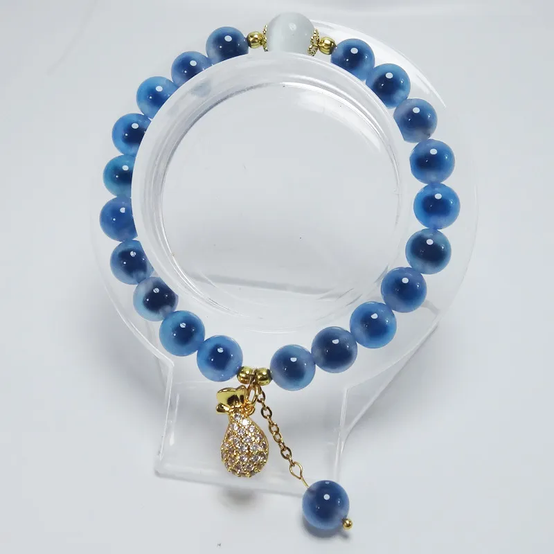 Women wearing fashionable blue agate crystal bracelet for office career style look.