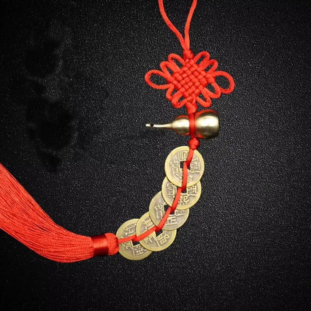 Feng shui lucky coin pendant displayed hanging on traditional wooden door.