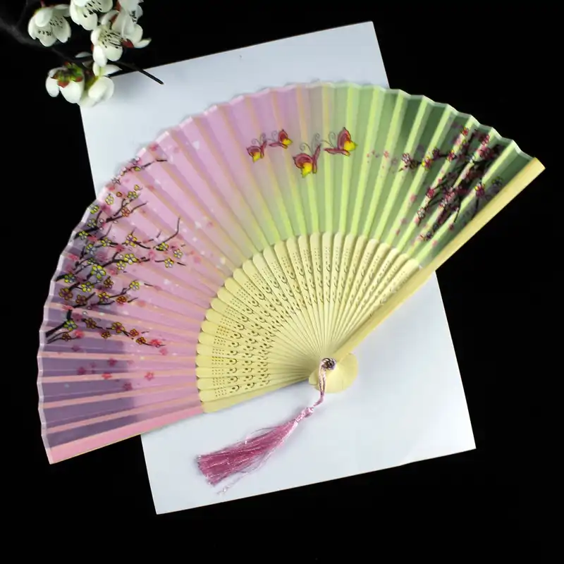 Close-up of fan pivot mechanism showing quality bamboo craftsmanship and smooth operation.