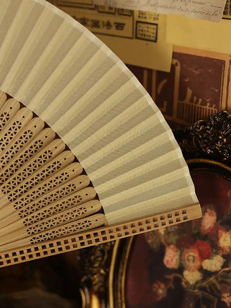 Ancient style bamboo fan positioned as summer cooling accessory in lifestyle setting.
