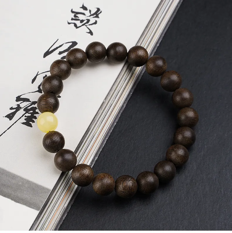 Genuine Nha Trang agarwood bracelet with beads arranged in meditation position.