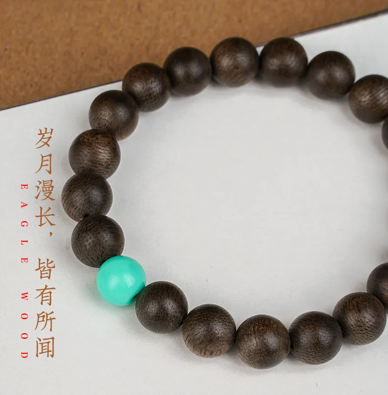 Premium wooden bracelet showcasing natural Kyara agarwood grain and oil patterns.