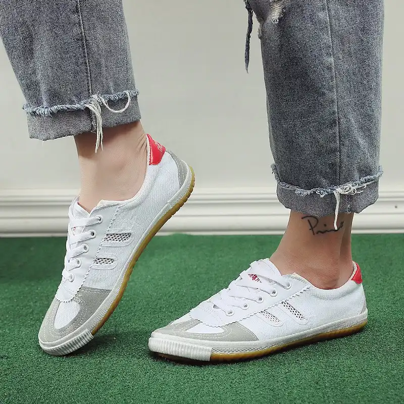 Side view of breathable canvas upper construction with traditional stitched design details.
