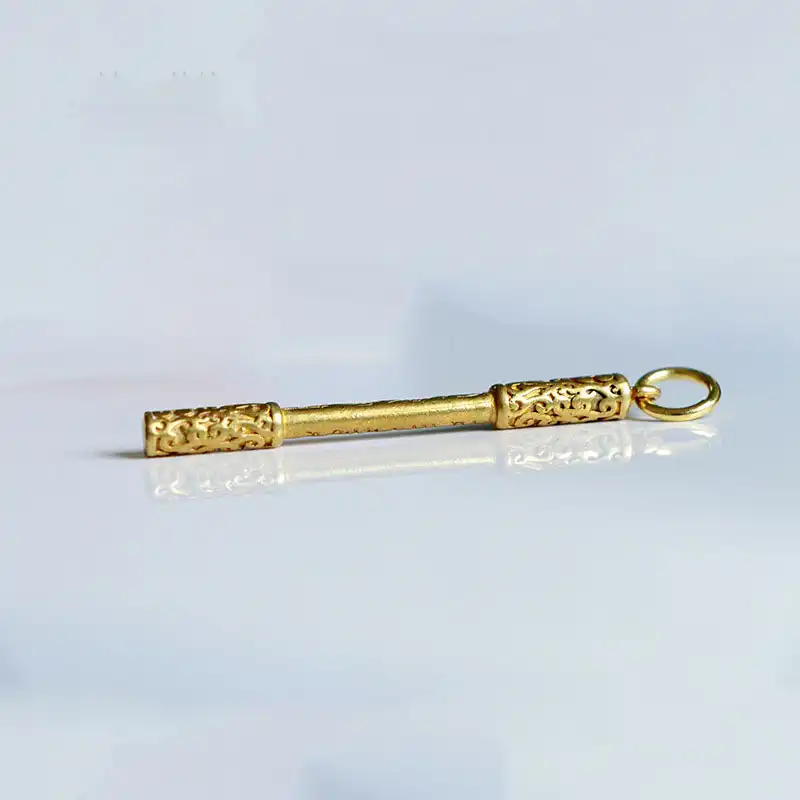 Black Myth Wukong metal keychain showing detailed Ruyi Jingu Bang replica with golden finish and zinc alloy construction.