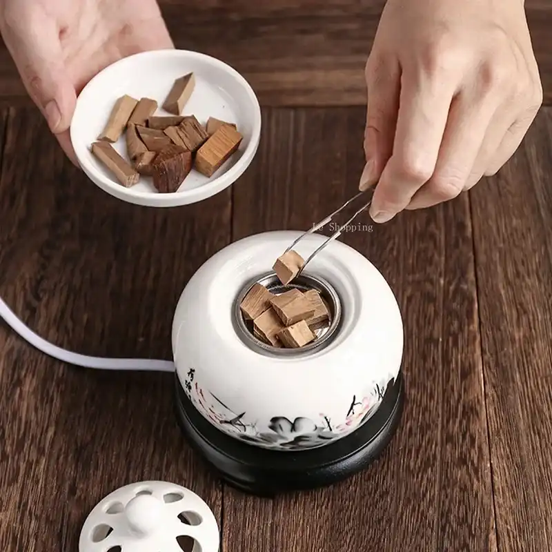 Ceramic incense burner in modern home office setting with aromatic smoke rising gently.