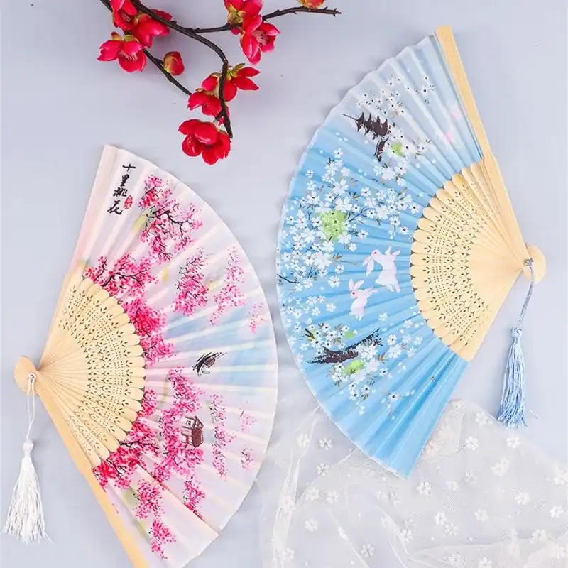 Model demonstrating fan use for dance performance showing graceful hand movements and positioning.