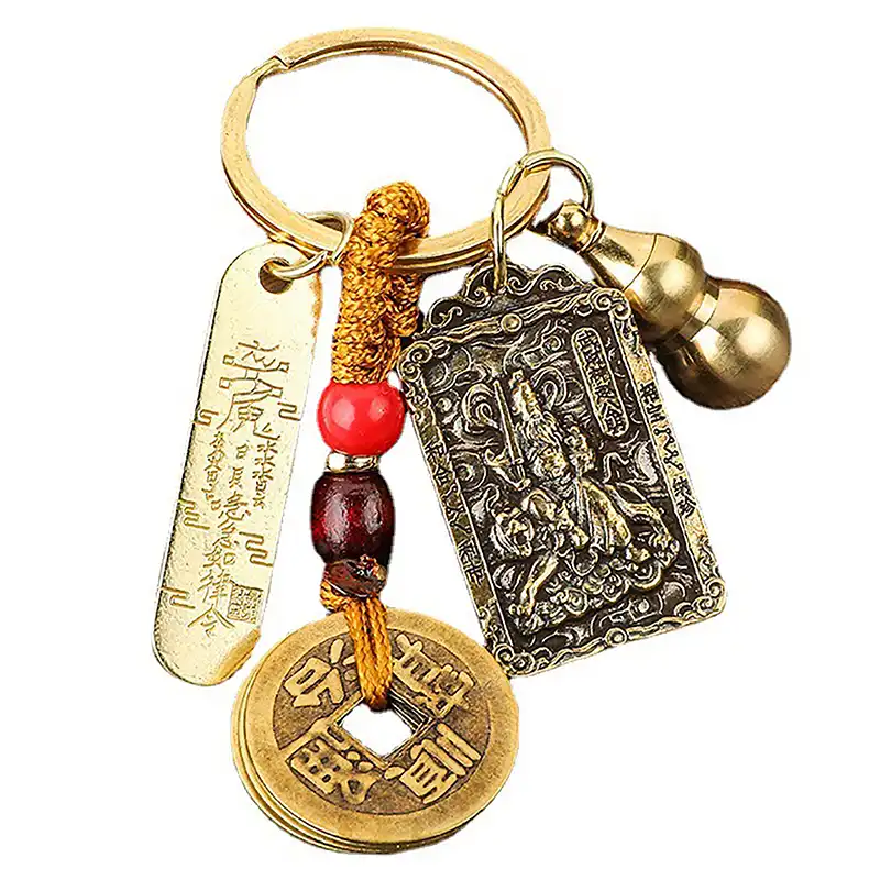 Close-up view of metal keychain showing detailed zodiac animal pendant and five emperor coins.