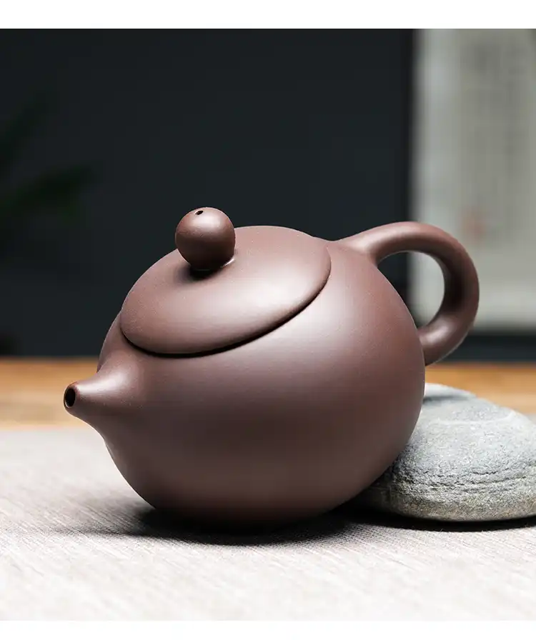 Xishi teapot with various tea leaves showing versatility for different tea variety brewing.