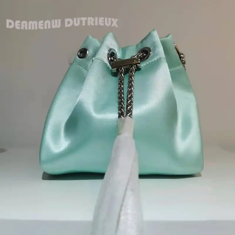 Tassel tie detail with ribbon accent creating dynamic movement and visual interest.