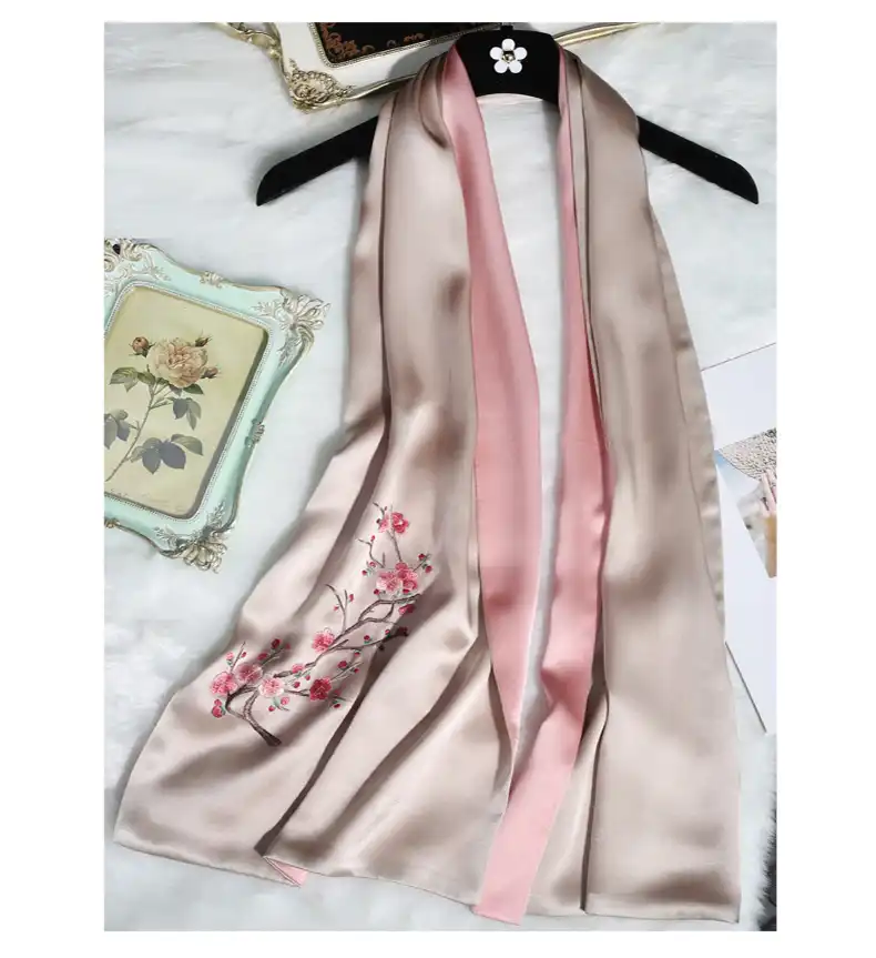 Double sided mulberry silk scarf featuring intricate hand embroidered floral motifs.