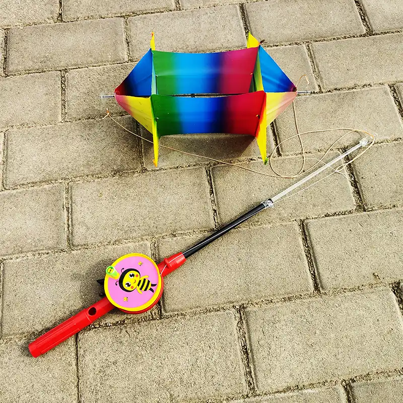 Detailed view of fish kite showing vibrant cartoon graphics and durable PE material.