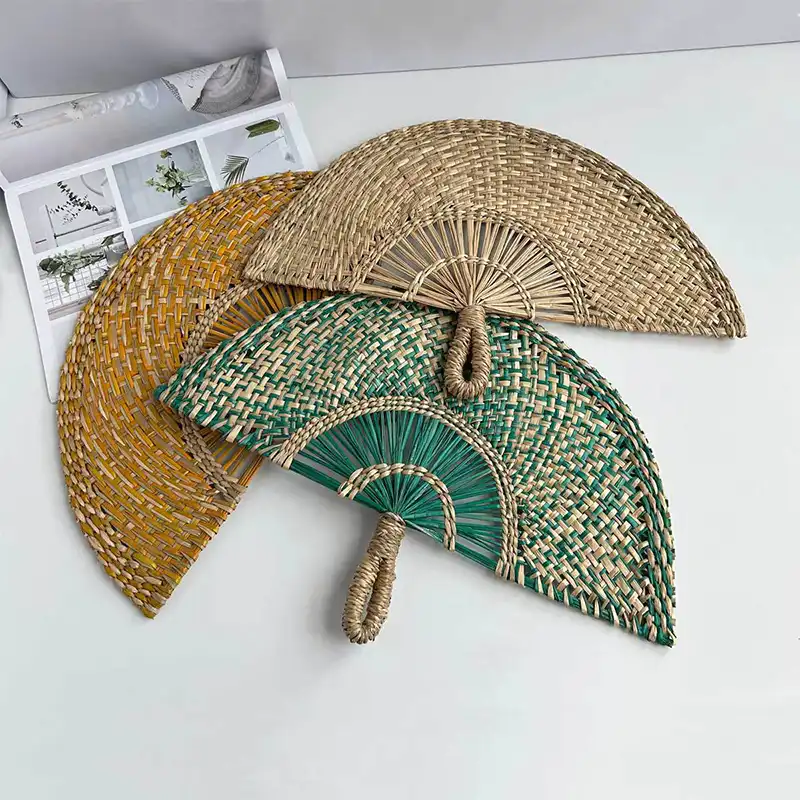 Handmade straw fan displayed as gift presentation highlighting natural materials and craftsmanship.