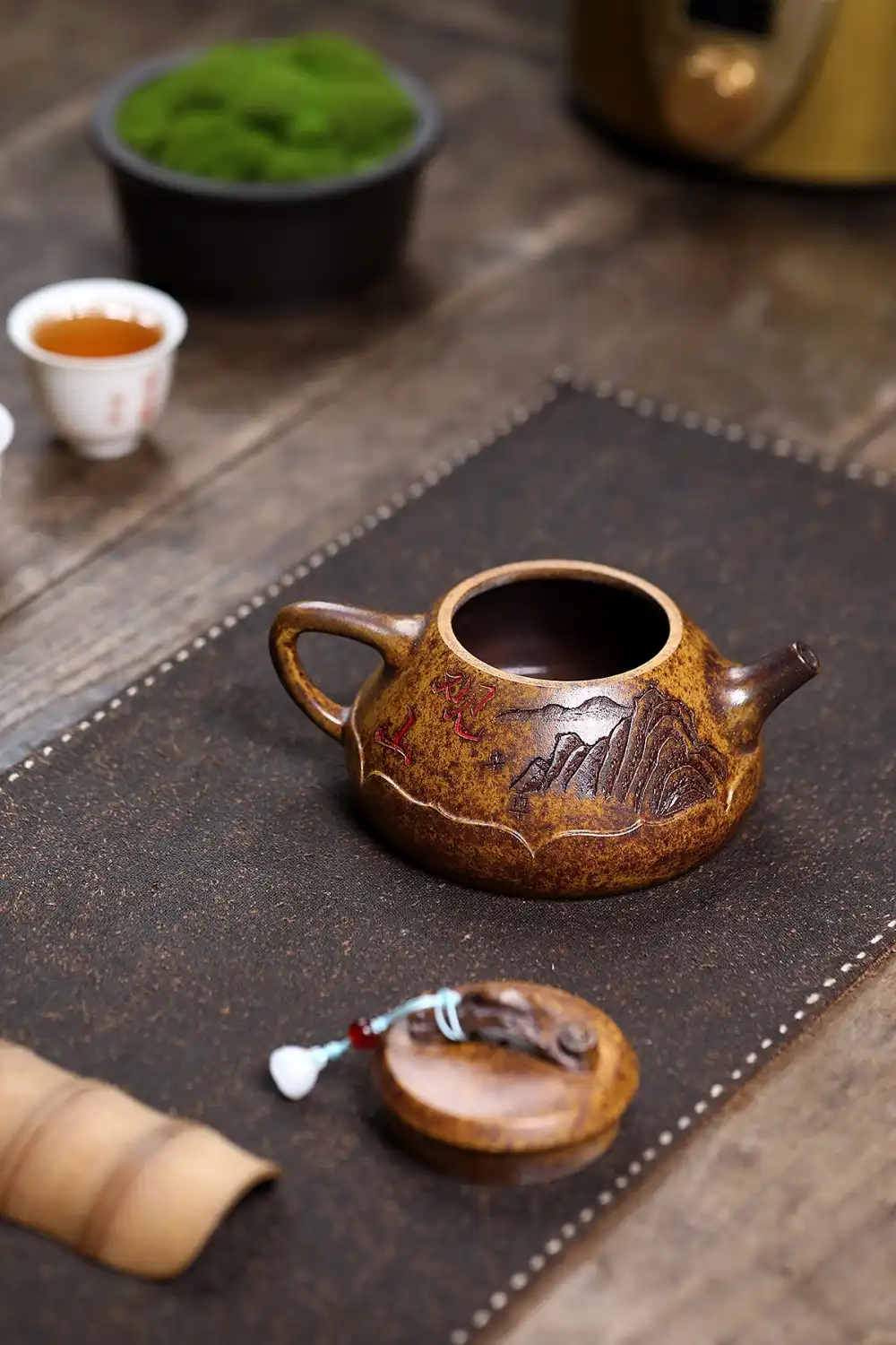 Firewood firing process creating unique color variations in each raw ore keel gold sand teapot.