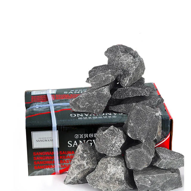 Sauna stones placed on electric heater showing proper installation in steam room environment.