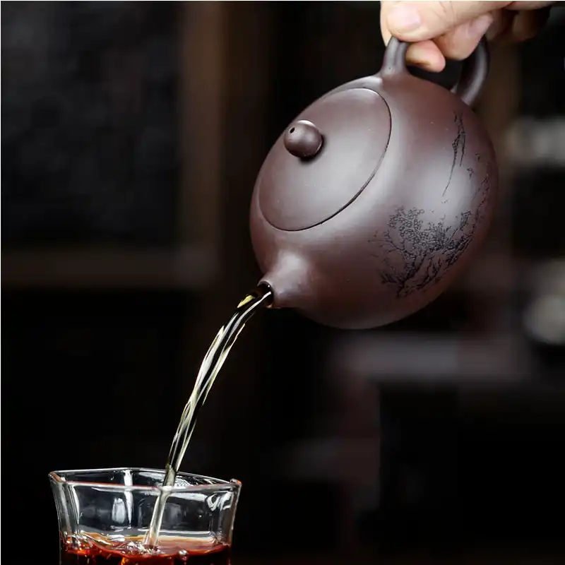 Close-up of purple clay teapot lid showing precise fit and traditional knob style construction.