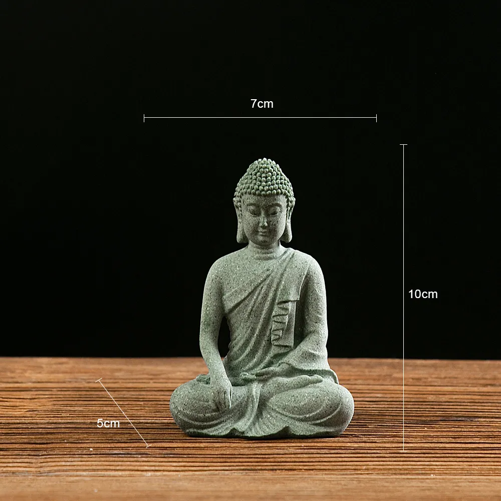 Mini stone Buddha figurine on office desk for meditation inspiration and workspace decor.