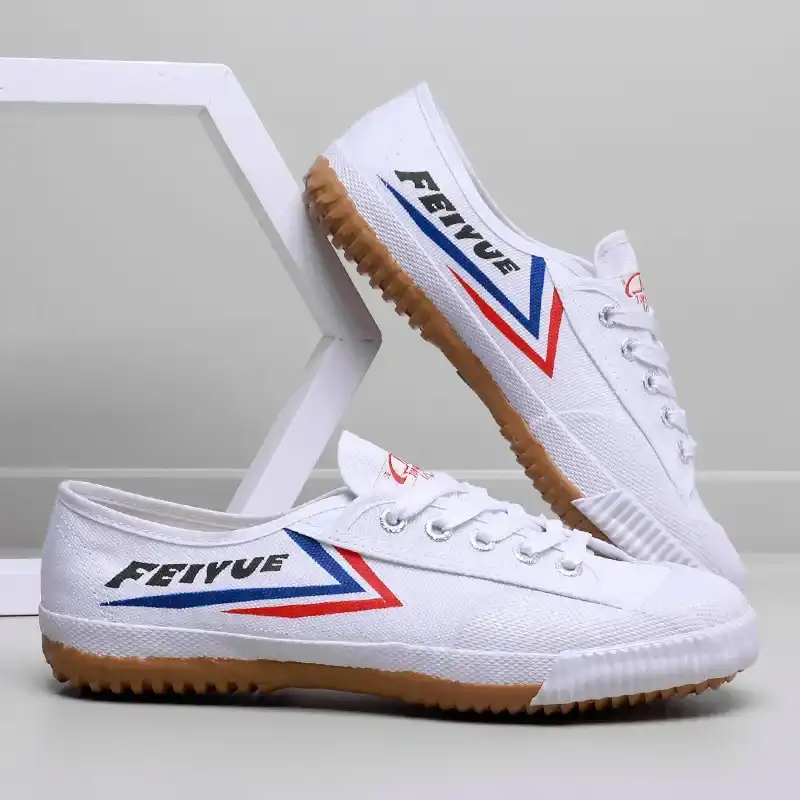 Side view of martial arts shoes showing flexible construction and ankle mobility design.