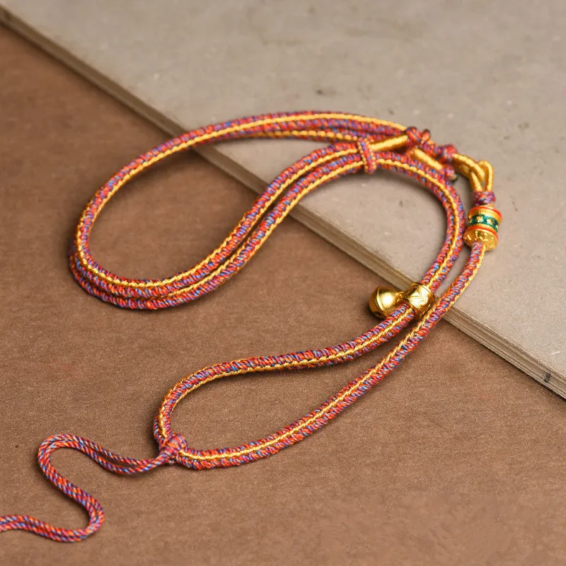 Copper alloy accent detail on Tibetan thangka pendant rope necklace ethnic jewelry.
