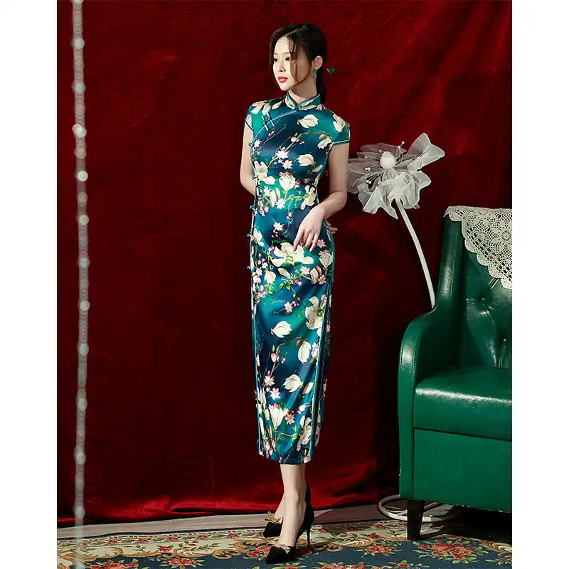 Side profile of women wearing red silk qipao dress highlighting the fitted silhouette and flowing length.