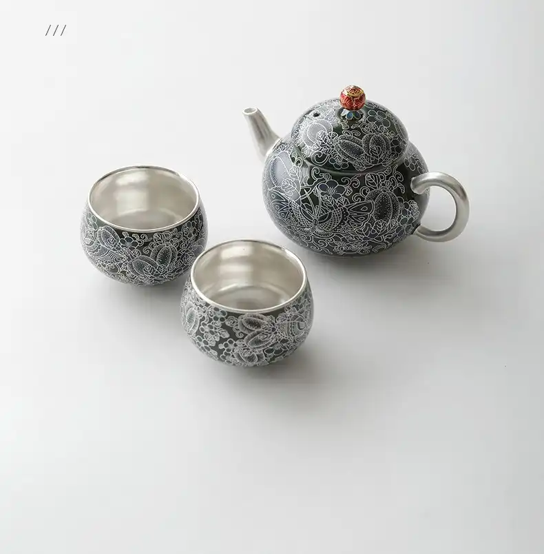 Close-up view of butterfly love flower pattern on ceramic teapot showing intricate artistic details.