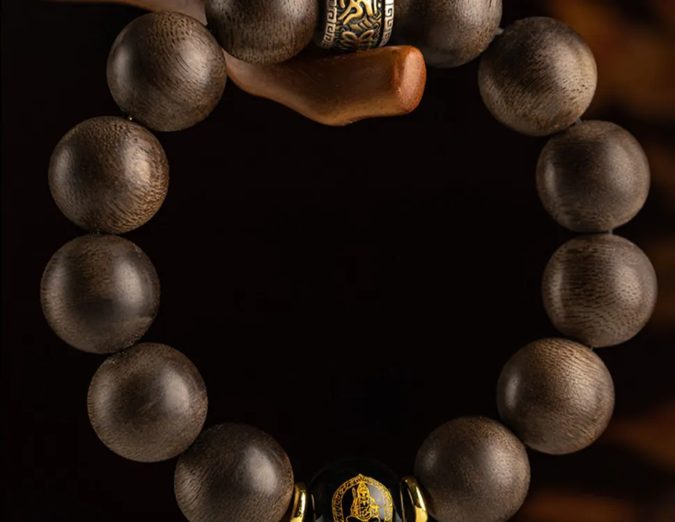 Natural agarwood beaded bracelet stretched showing elasticity and comfortable fit for men.