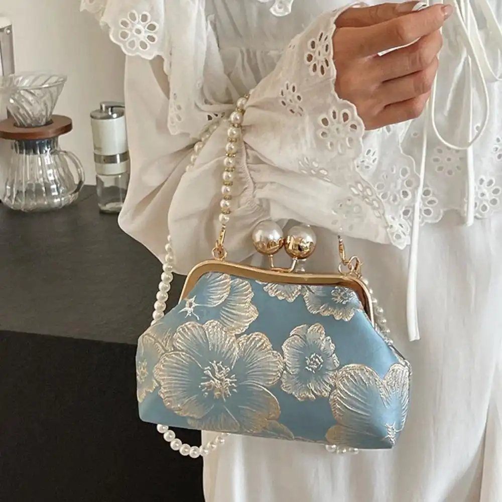 Evening banquet scene with woman carrying pearl embroidery clutch bag elegantly.