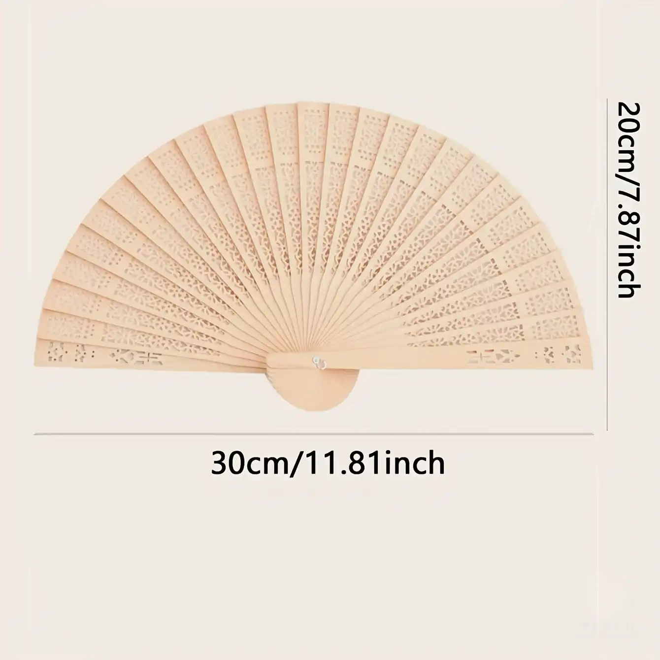 Wooden hand fan displayed as home decoration piece against neutral background.