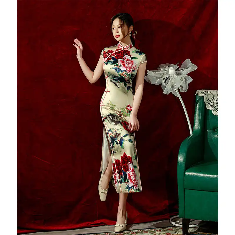 Traditional qipao dress fabric pattern close up showing silk quality and color richness.
