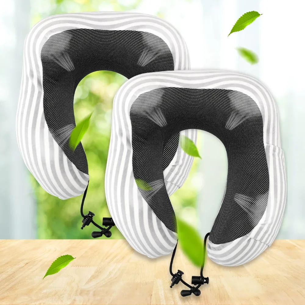 Person relaxing in office chair using U-shaped pillow for neck support during work breaks.