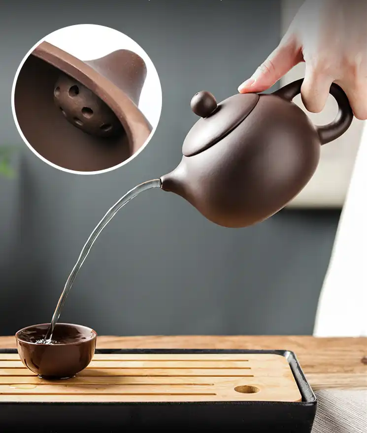 Traditional Chinese tea ceremony setup with antique Xishi teapot as elegant centerpiece.