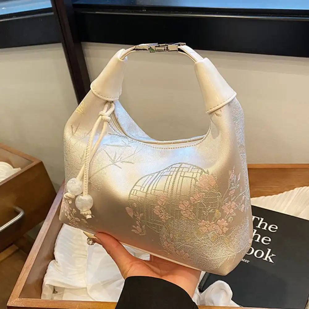 Woman carrying embroidered canvas tote bag in professional work environment setting.
