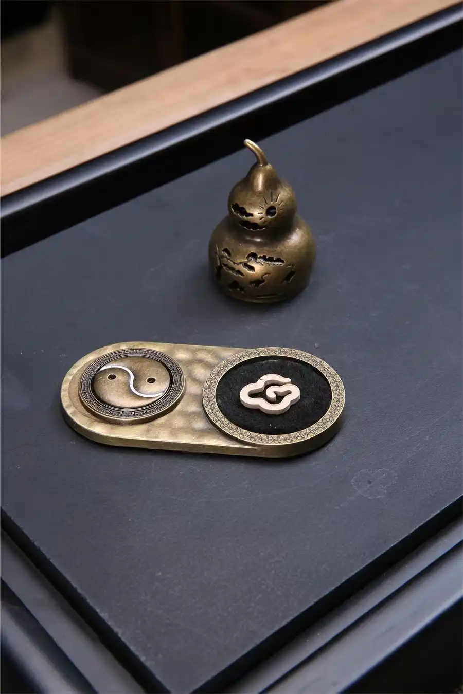 Size comparison of compact bronze incense holder perfect for tea ceremony and home decoration.