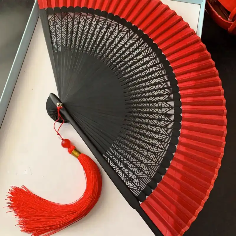 Bamboo ribs construction of portable folding fan highlighting green natural material quality.