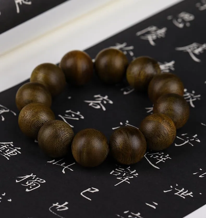 Hand wearing agarwood Buddhist prayer bracelet demonstrating comfortable fit and elegant appearance.
