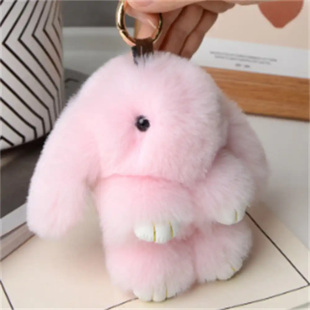 Multiple rabbit fur pendants in different colors arranged showing variety and gift options.