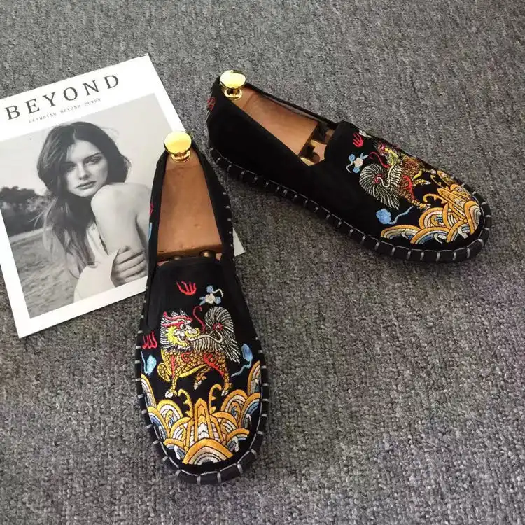Old Beijing embroidered shoes photographed from above showing symmetrical flower pattern design.
