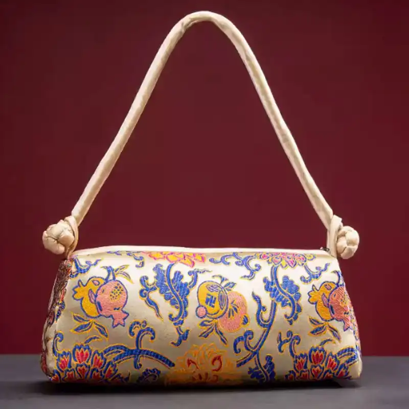 Silk embroidered bag positioned on elegant surface highlighting luxury texture and craftsmanship.