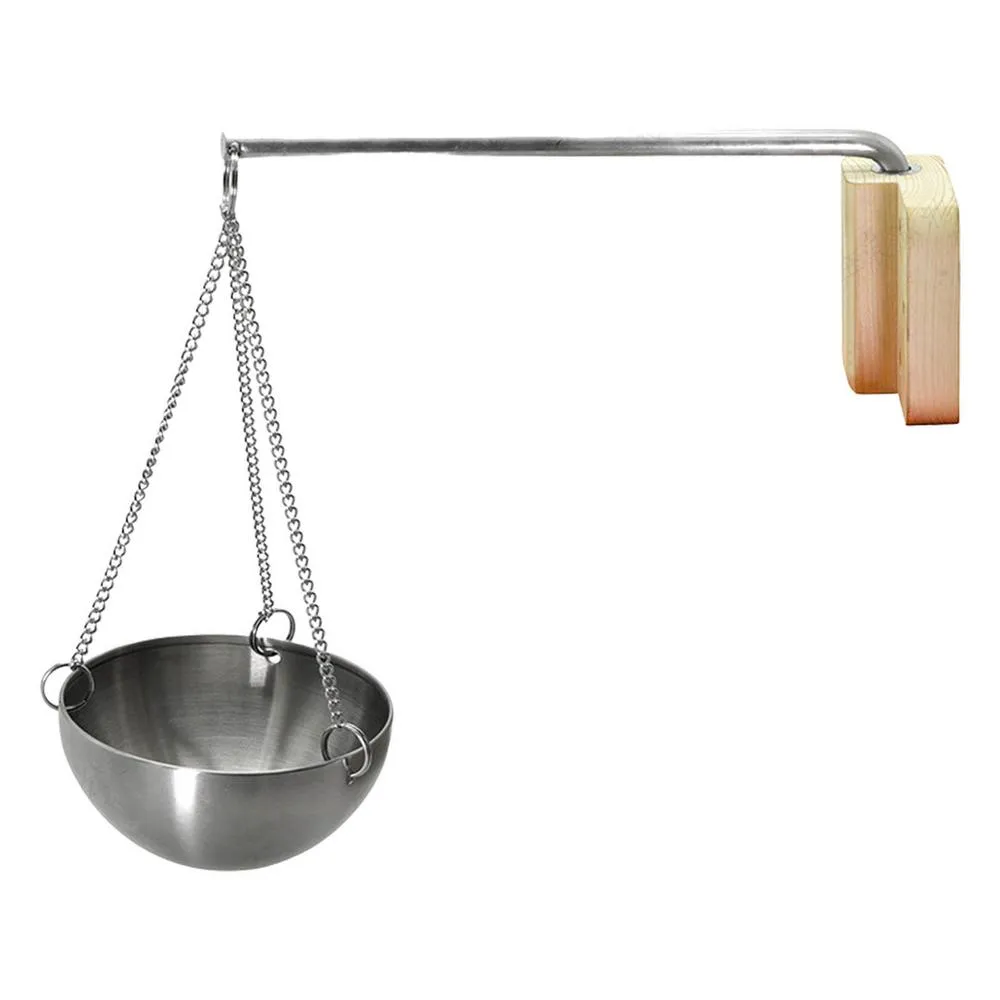 Wall mounted sauna aromatherapy holder with extendable metal arm above sauna heater stones.