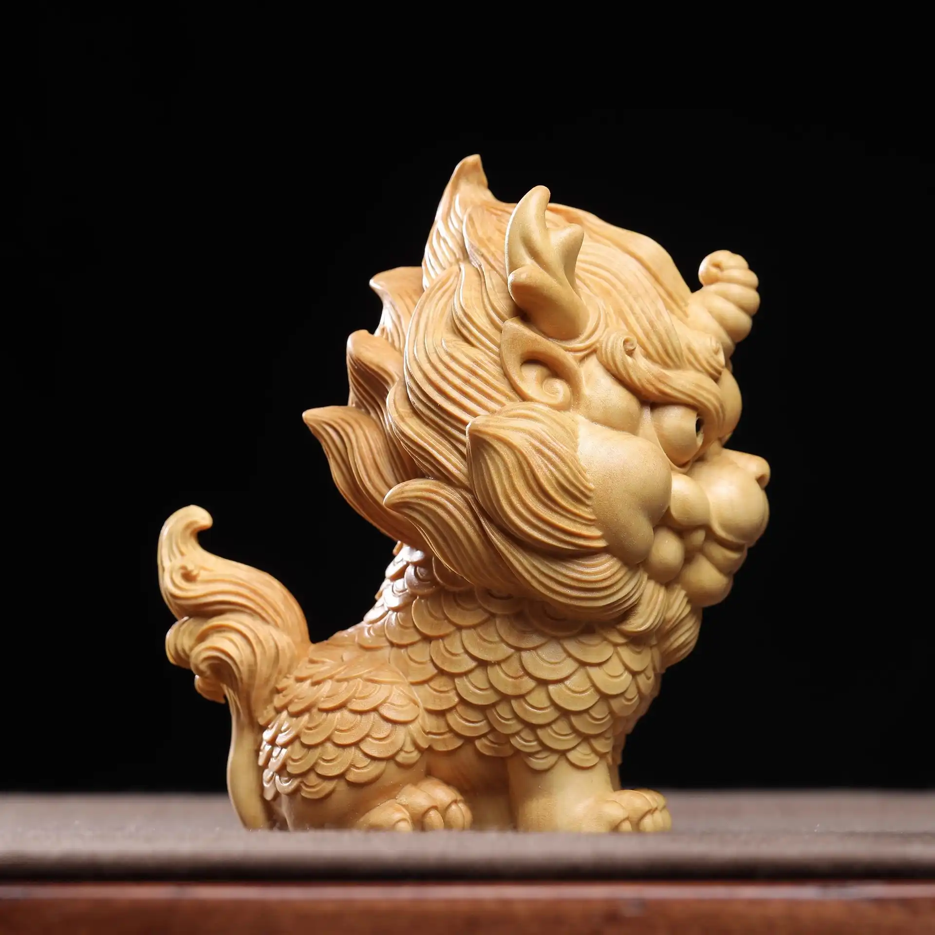 Hand-carved miniature Qilin figurine in home setting showcasing collectible souvenir quality.
