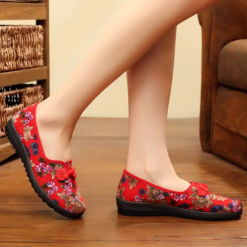 Embroidered flats worn on feet displaying comfortable casual style with traditional Chinese design.