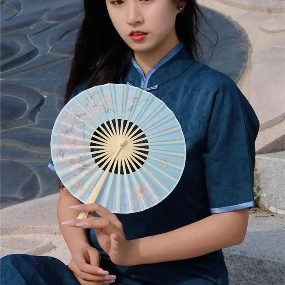 DIY customization example of round silk fan used as craft project canvas.