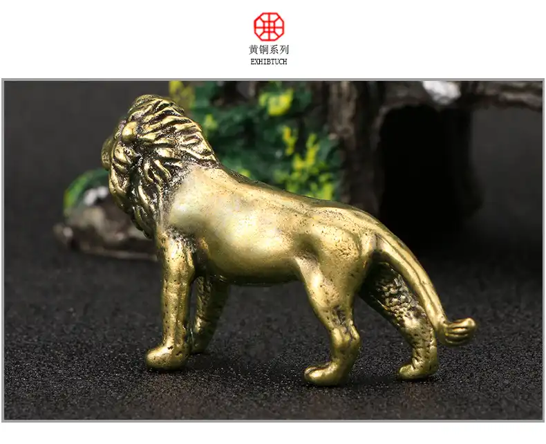 Living room setting with lion ornament displayed on coffee table among other home decorations.