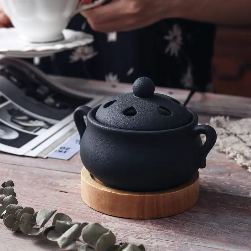 Ceramic incense burner accessories including precision clip and measuring spoon for safe handling.