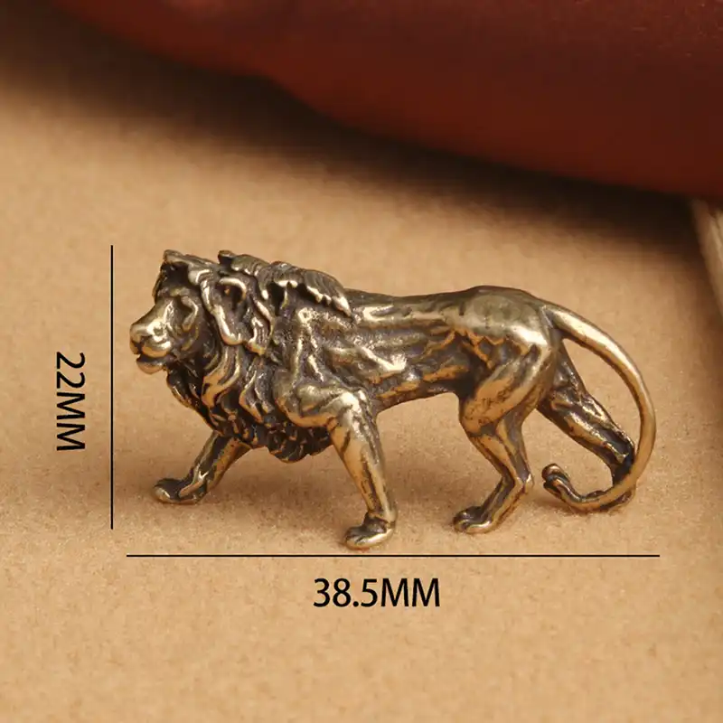 Lion miniature statue placed on wooden desk demonstrating size and decorative appeal.