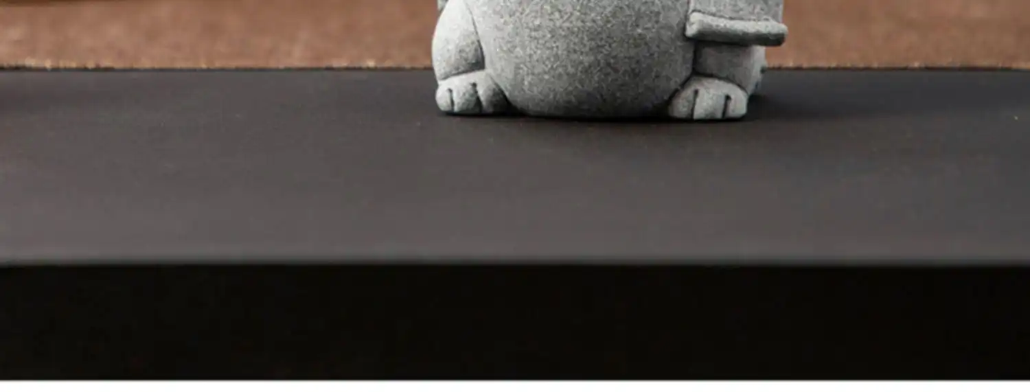 Natural lighting showcase of stone cat tea pet revealing authentic material beauty.
