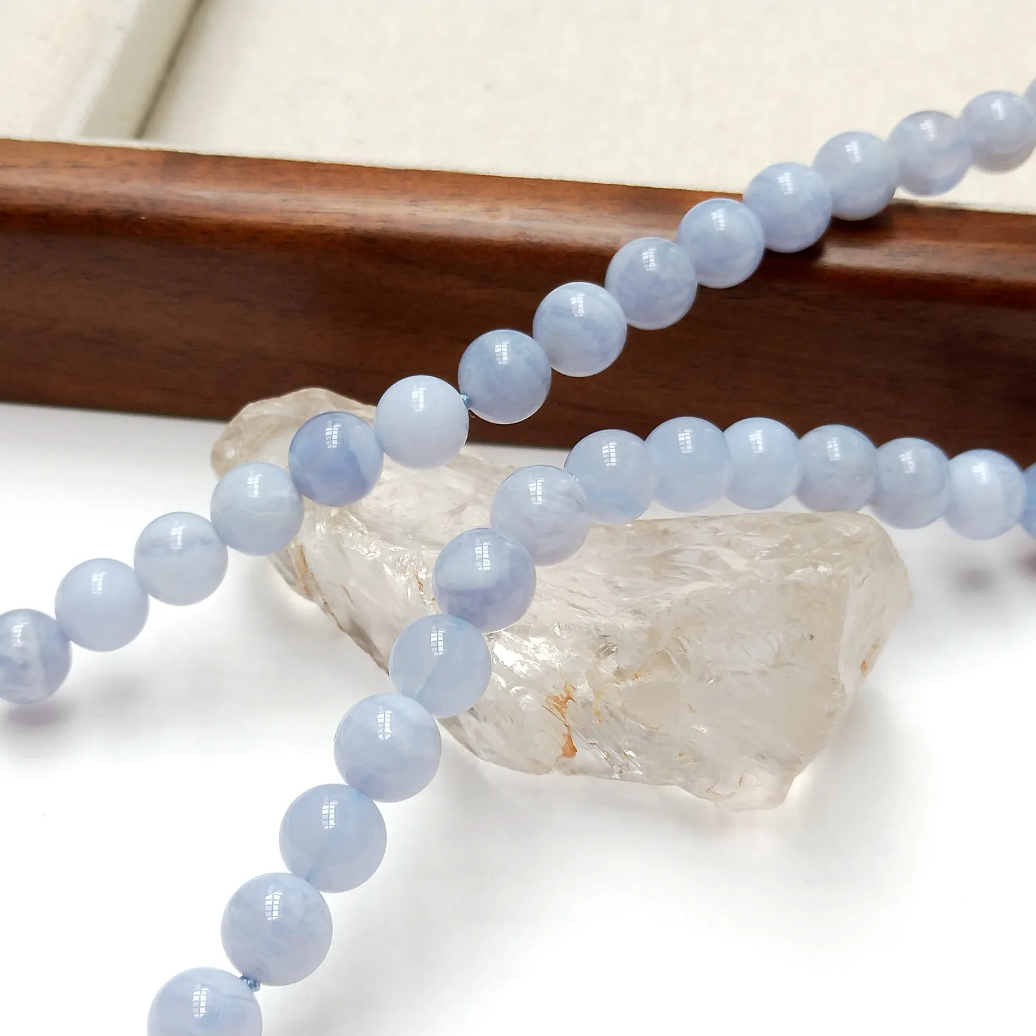 Close-up of 8mm Blue Lace Agate beads showing translucent blue bands and premium stone quality.