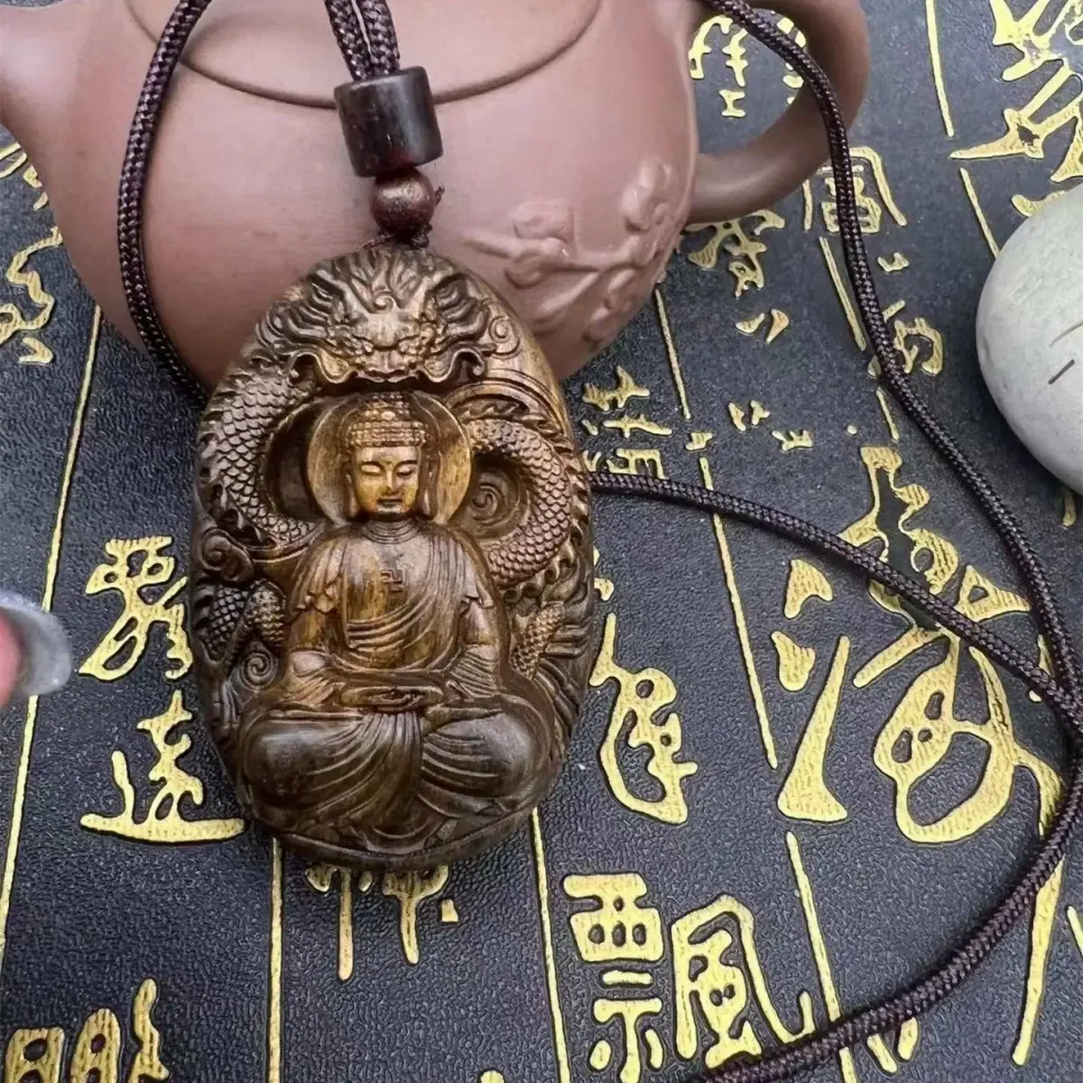 Sandalwood Buddha necklace in meditation setting with peaceful home decor background.