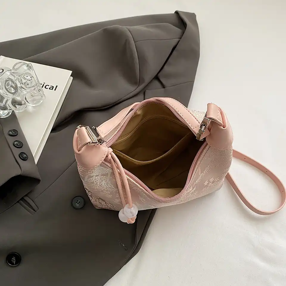 Small handbag size comparison with everyday items for scale reference.