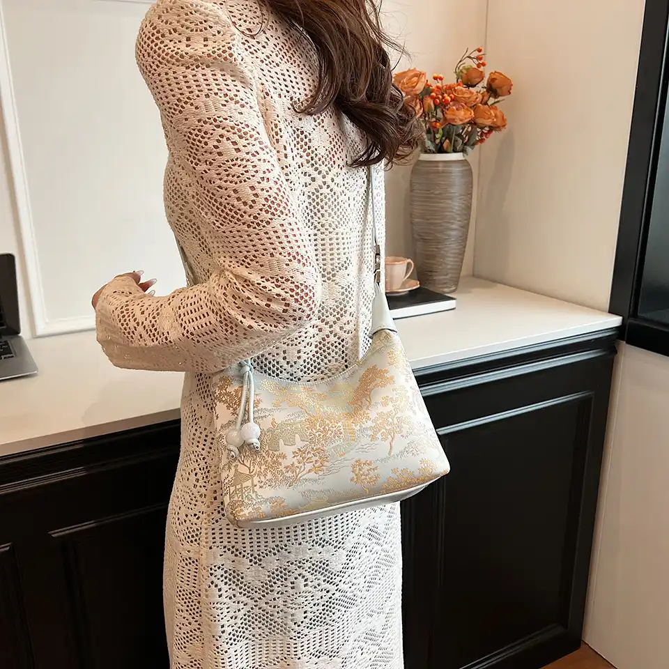 Cultural celebration styling with embroidery bag as statement accessory.