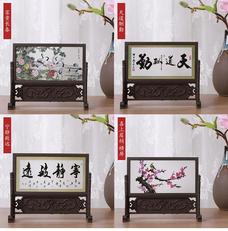 Small table screen positioned between books and office supplies as functional desk organizer.